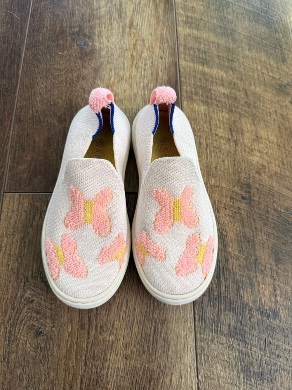 Rothy's Kids Slip-On Sneakers in Light Pink with Coral Butterfly Accents